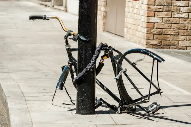 Abandoned bike missing wheels.